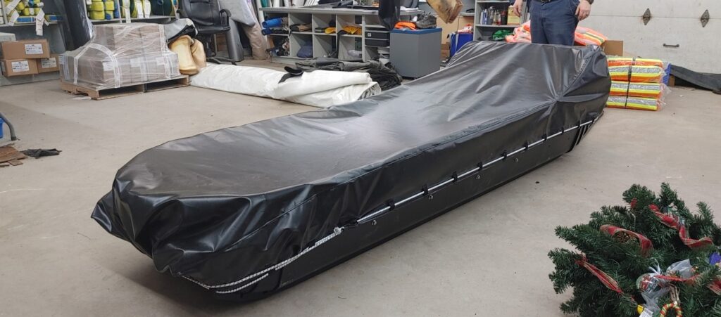 Custom black protective cover fitted to a Yukon sleigh, created by Byron's Industrial